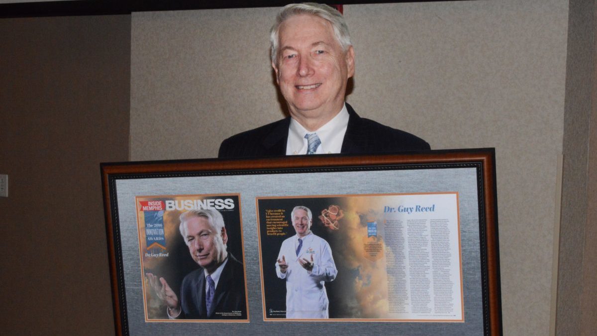 Dr. Guy Reed, pictured with his award and magazine spread