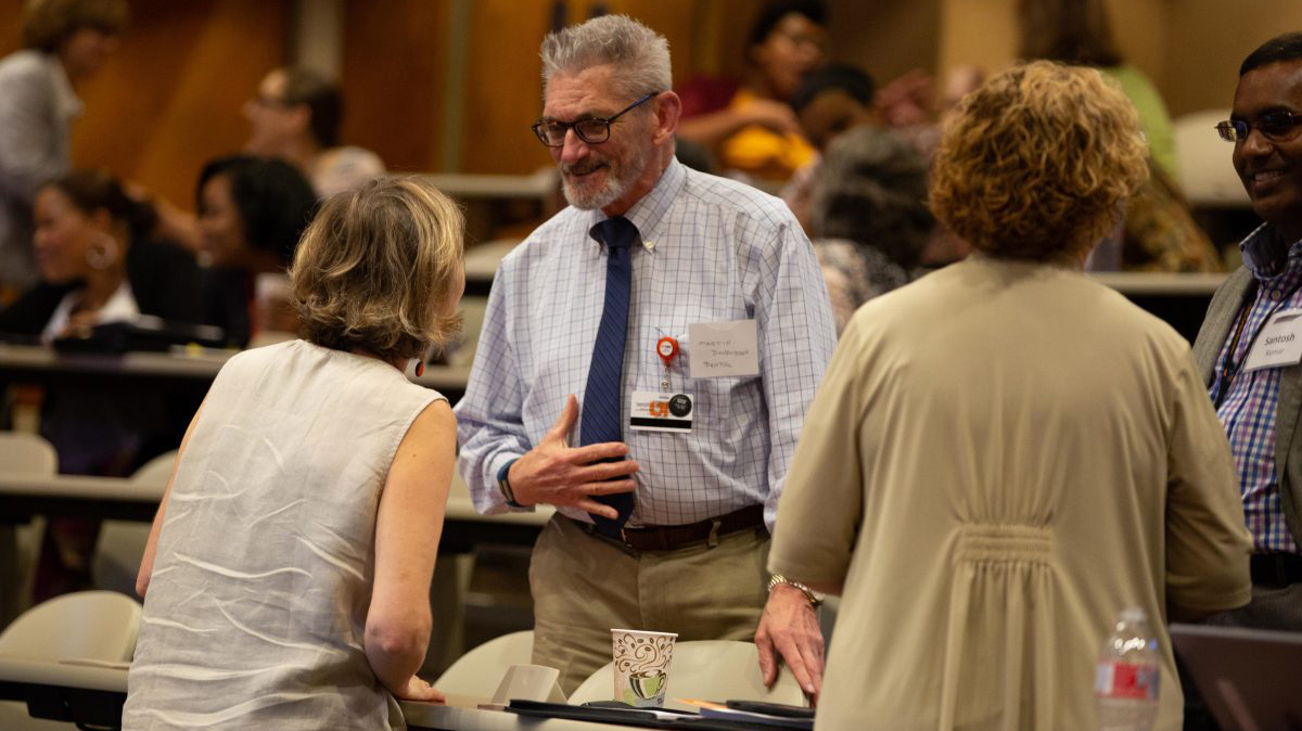 Faculty and staff from all across the UT System interact with each other during a networking activity.