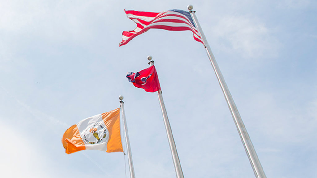 The U.S. Tennessee and University of Tennessee flags fly over the Howard Baker Center