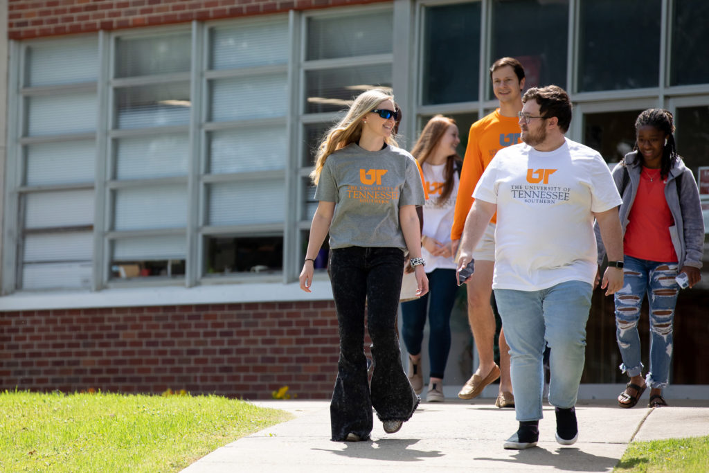 A group of students walks and talks on the campus of UT Southern in Pulaski
