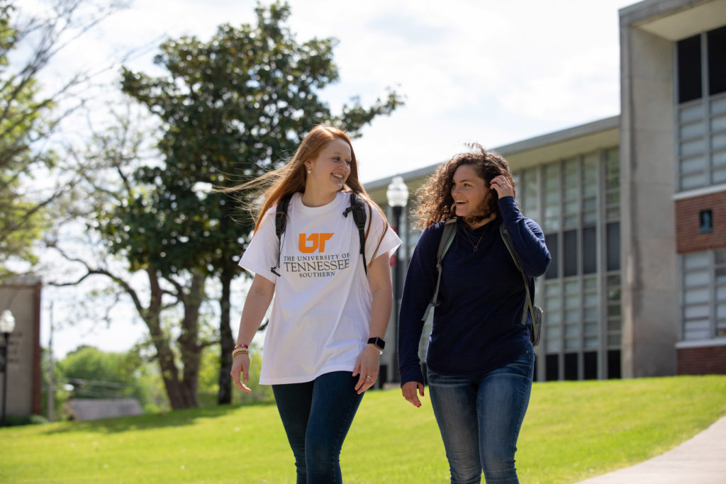 Two women, one in a UT Southern tee shirt walk on the Pulaski campus