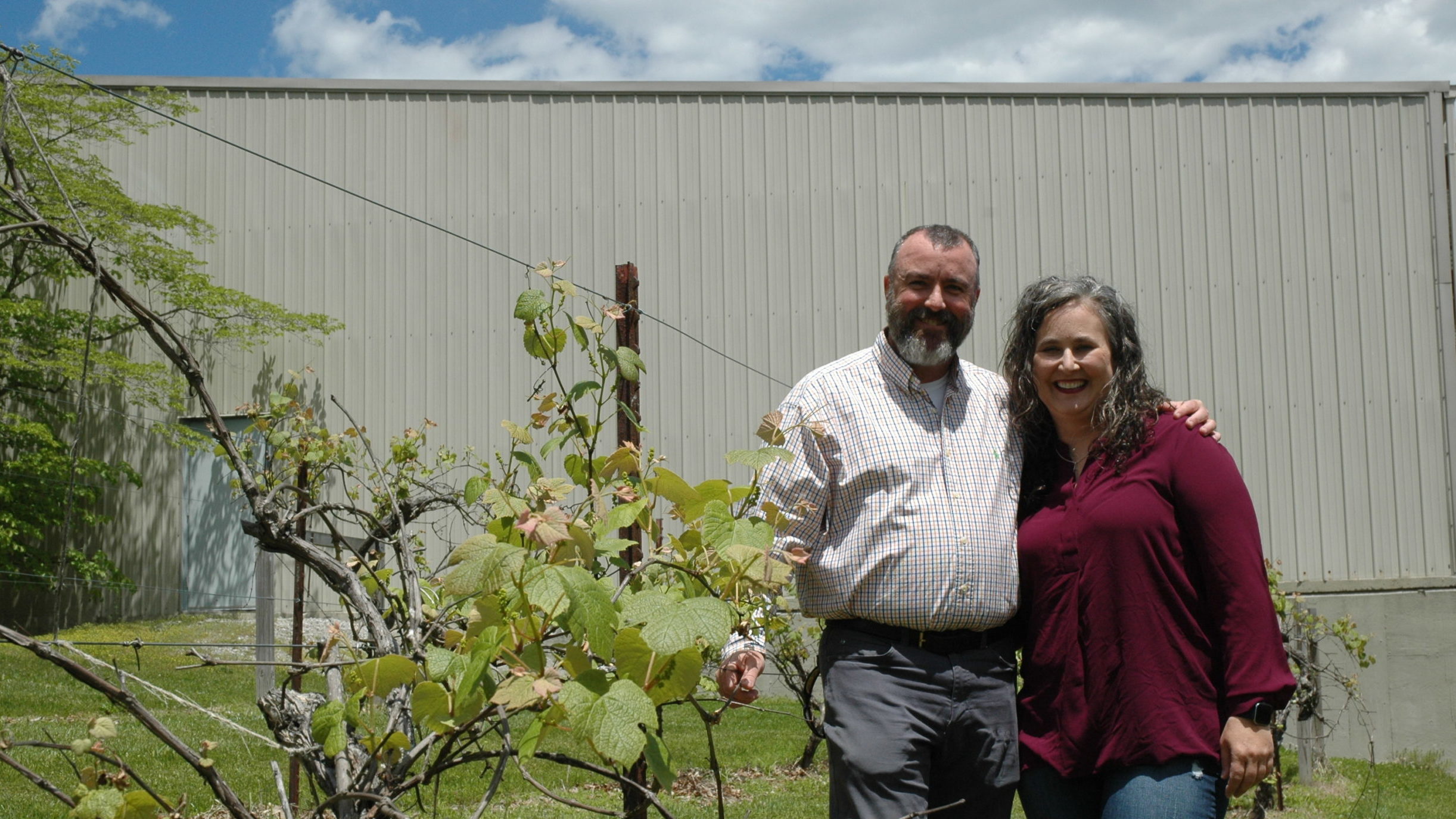 Fred and Rhonda Moody standing next to vineyard