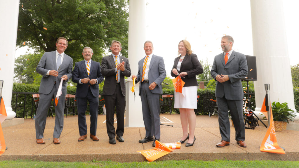state officials cut the ribbon with Mark La Branche , Randy Boyd and Gov. Bill Lee