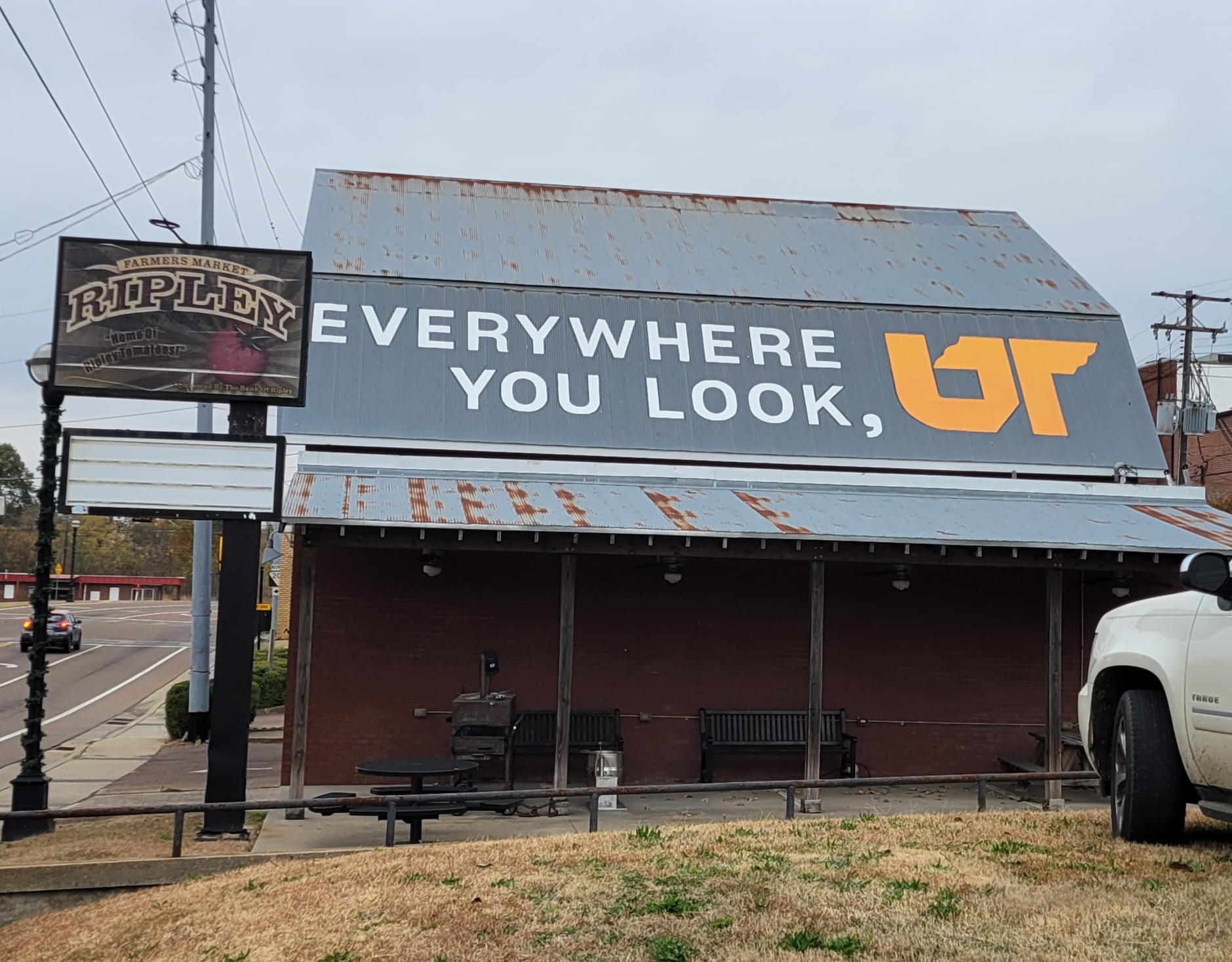 Orange and white "Everywhere You Look, UT" mural on metal roof of barn